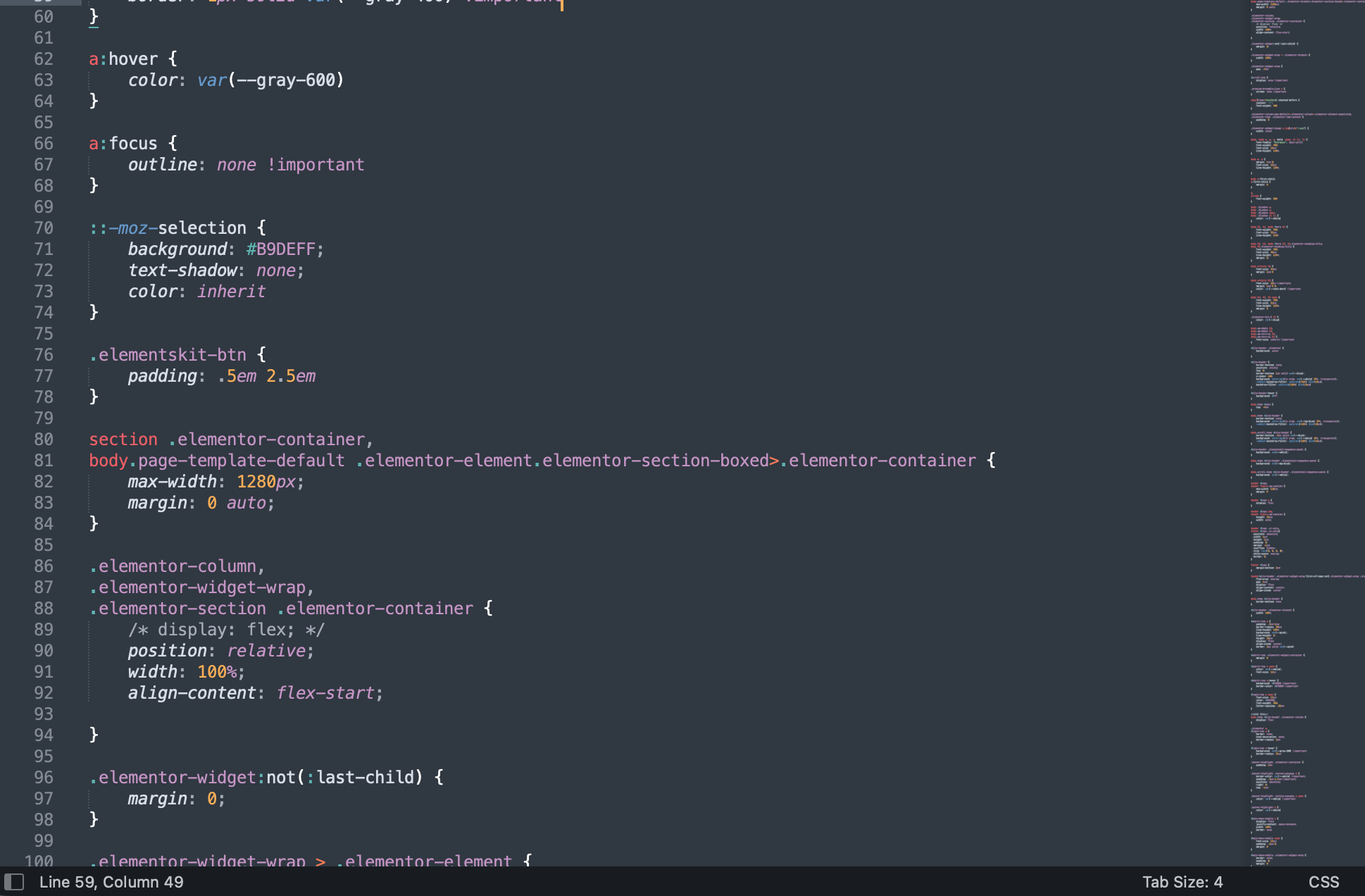Person at standing desk working on laptop
